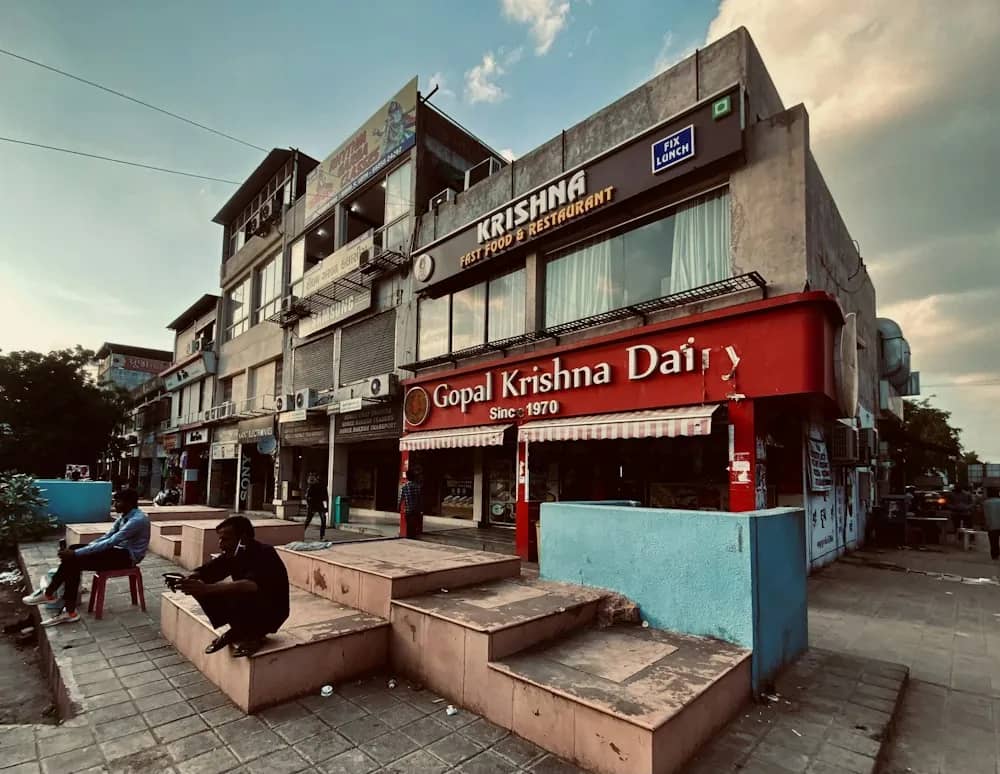 A row of shopfronts in a Gandhinagar commercial block