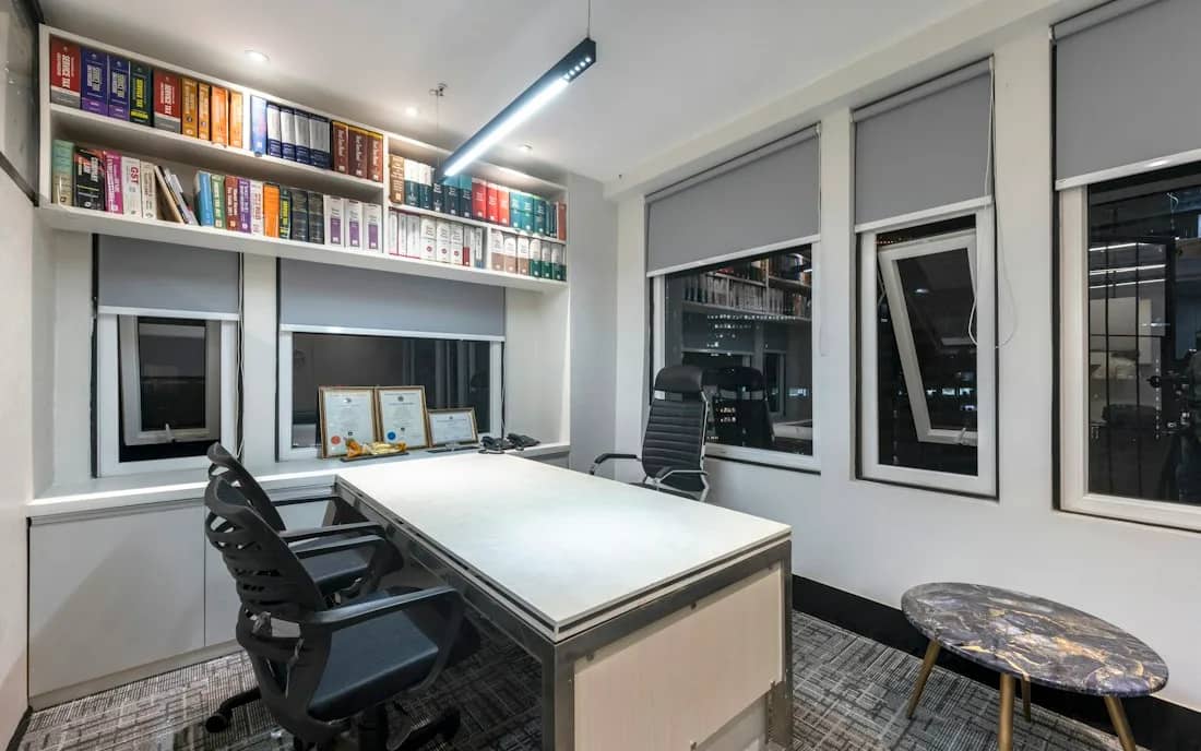 A one-person workspace with a desk and laptop