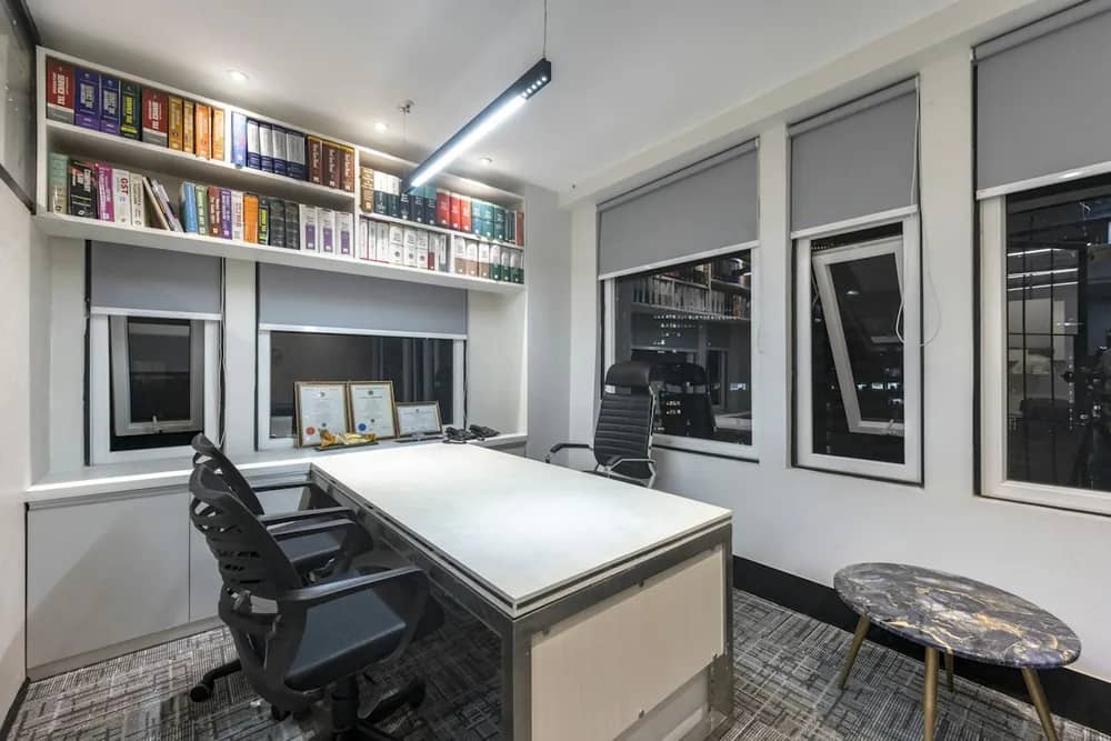 A small private office with a desk and a shelf of files