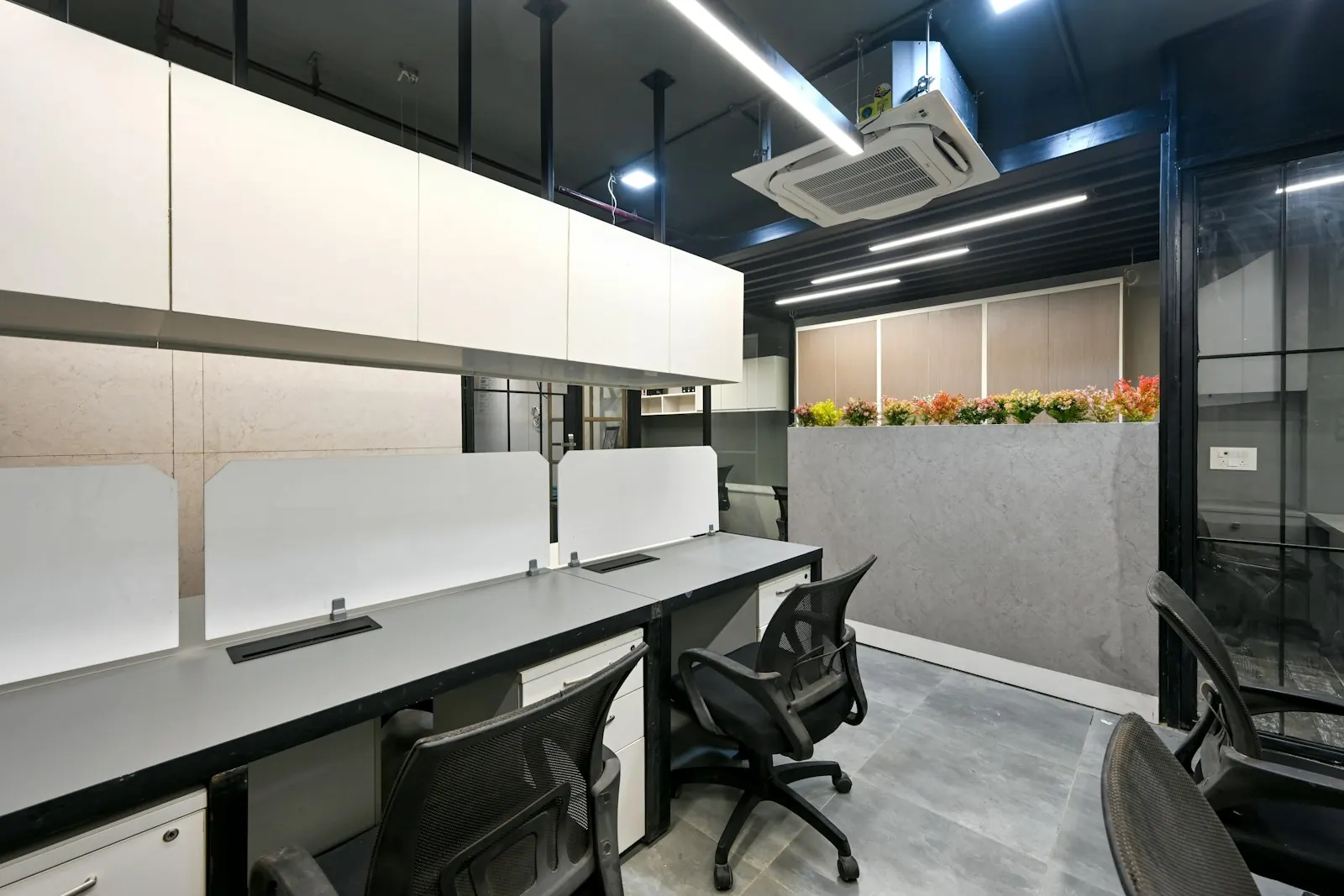 An office with workstations and a meeting area