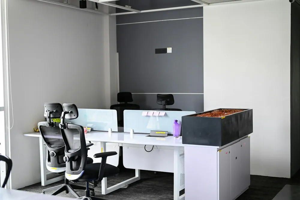 A modern office with desks and ergonomic chairs